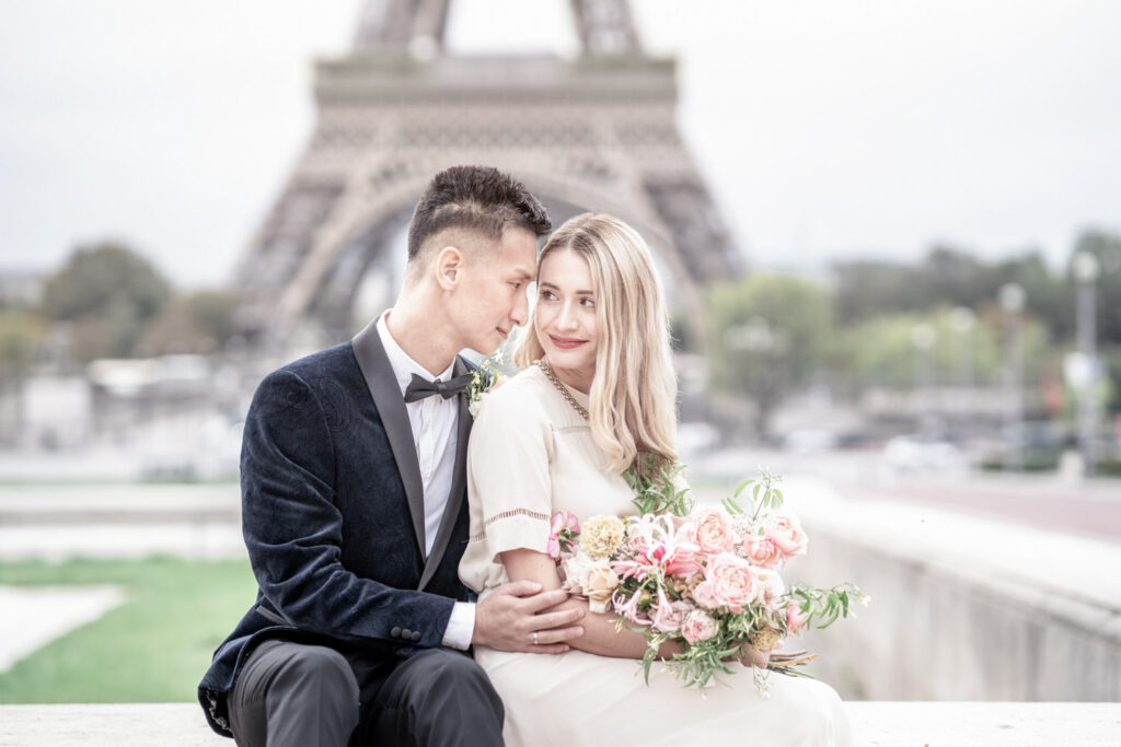 Bride and groom say by the fountains of Trocadero in front of the Eiffel Tower in Paris