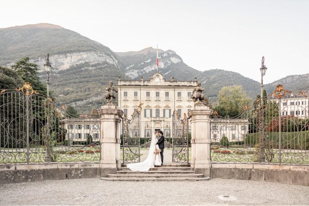 Bride and groom posing outside of Villa Sola Cabiati in Italy