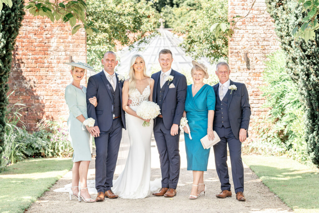 Formal group wedding photo of bride and groom with each set of parents