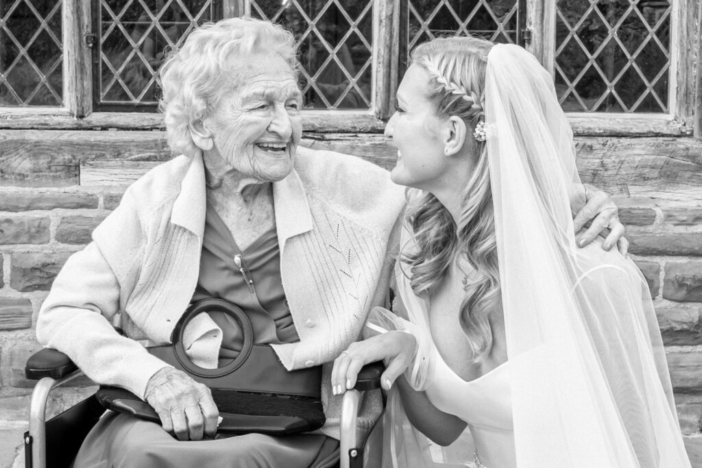 Photo of bride hugging and looking at her grandmother