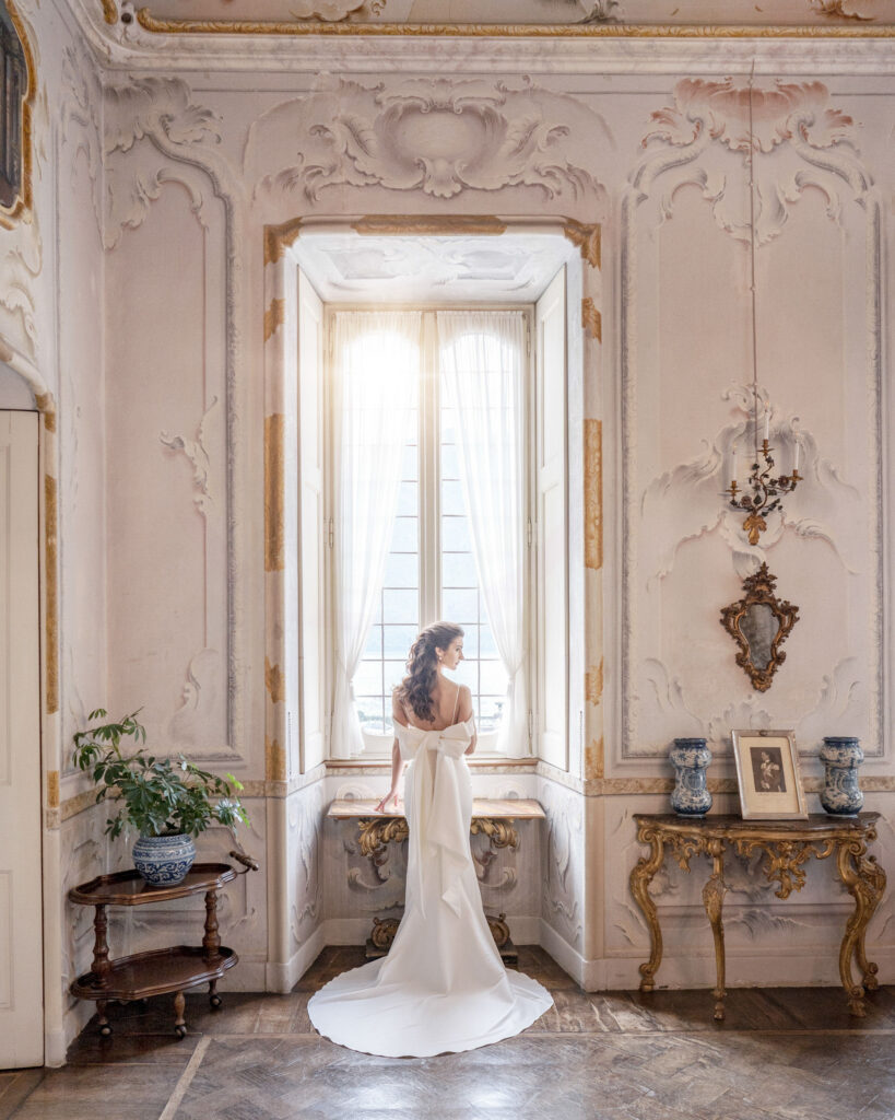 Fine art style photo of bride standing in front of the window at Villa Sola Cabiati