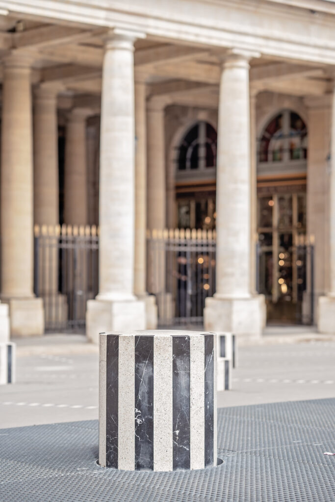 Close up of one of the black and white columns at Palais Royale in Paris