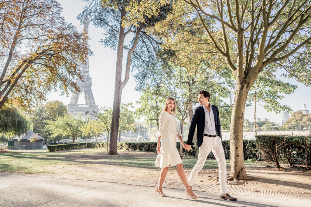 Couple walking hand in hand through the Trocadero gardens