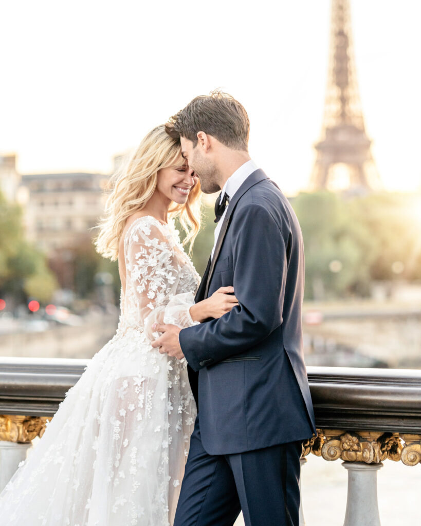 Bride and groom posing on the pont alexandre III bridge in Paris