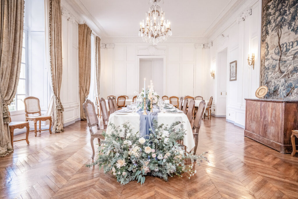 The dining room dressed for a wedding dinner with fresh flowers at Chateau de Courtomer in Normandy, France.