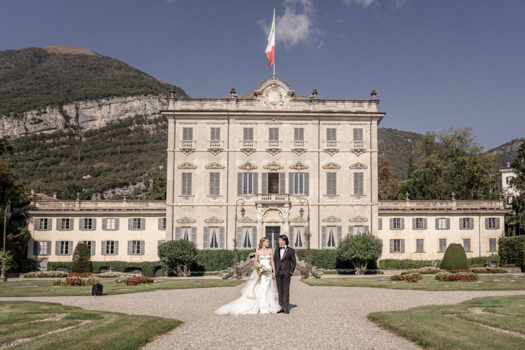 Bride and groom standing in front of Villa sola cabiati on lake como