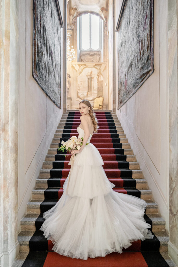 Bride posing on the stairs at villa sola cabiati wedding venue on lake como