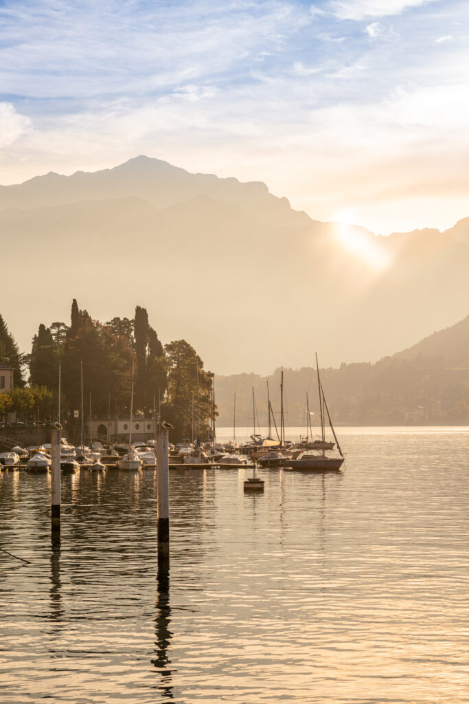 Sunset photo over Lake Como in Italy with sailboats and mountains