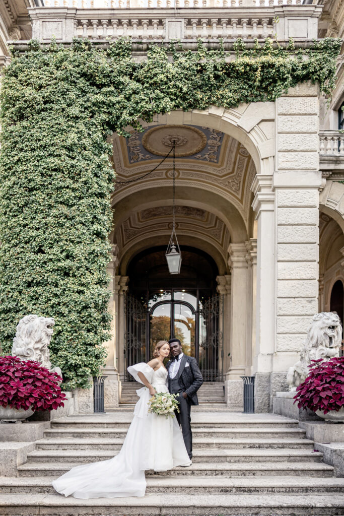 Bride and groom posing on the steps outside of Villa Erba on Lake Como in Italy