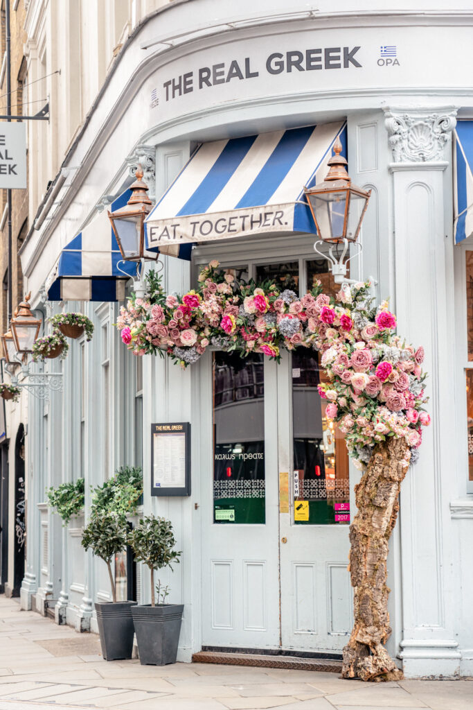 The outside of London cafe with florals in Notting Hill in London