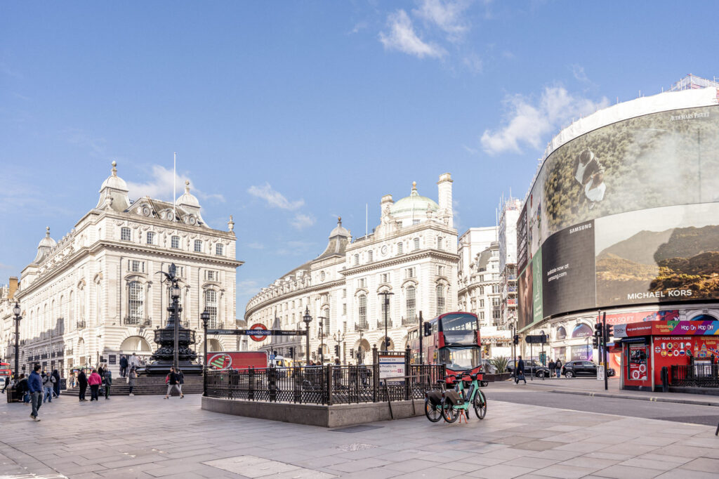 Picadilly circus with a double decker bus and large digital billboards