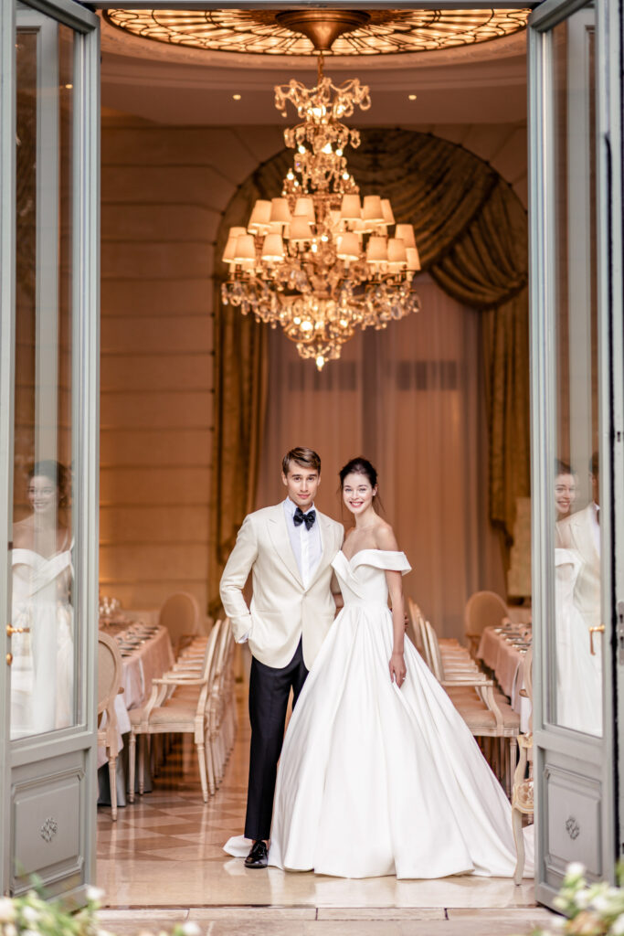 Bride and groom posing in the reception room at the Hotel Ritz in Paris