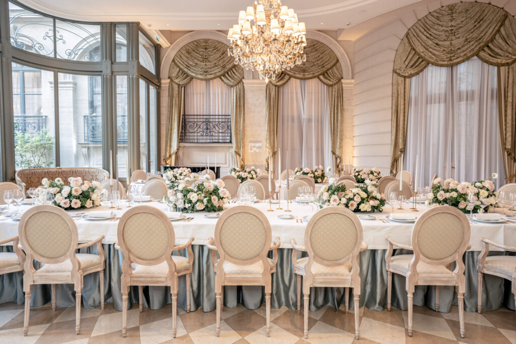 Salon d'Été at the Ritz Paris hotel set for a formal wedding dinner with floral centerpieces