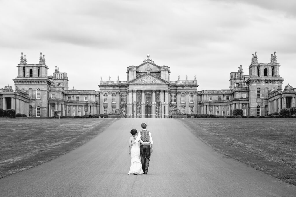 Bride and groom walking arm in arm up the driveway outside towards Blenheim Palace wedding venue in Oxfordshire