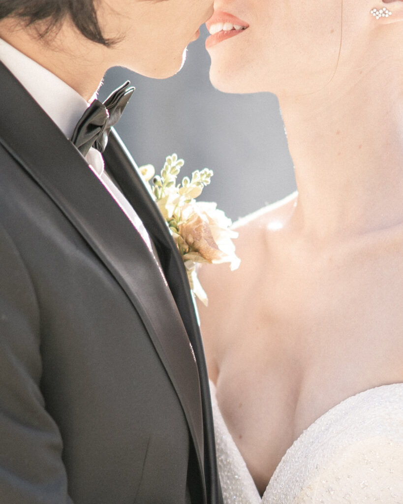 Close up editorial portrait of bride and groom about to kiss