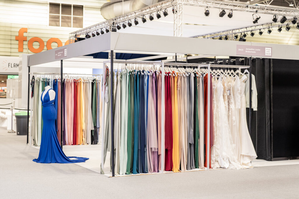 A bridesmaids dress stand at the national wedding show offering lots of different colours