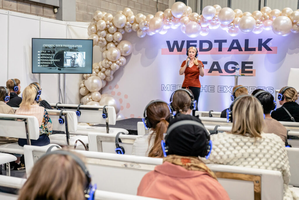 Victoria Amrose speaking on the wedtalk stage at the national wedding show to bride and grooms to be