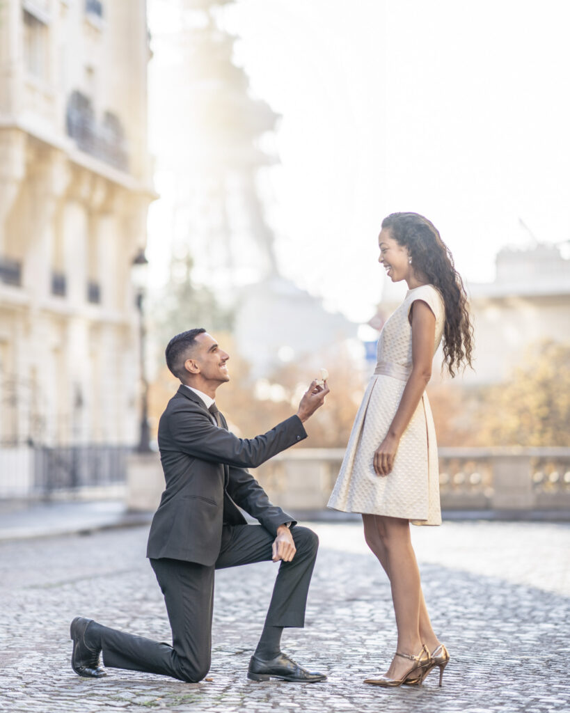 Man proposes to his girlfriend on the Avenues des Camoens in front of the Eiffel Tower in Paris. 