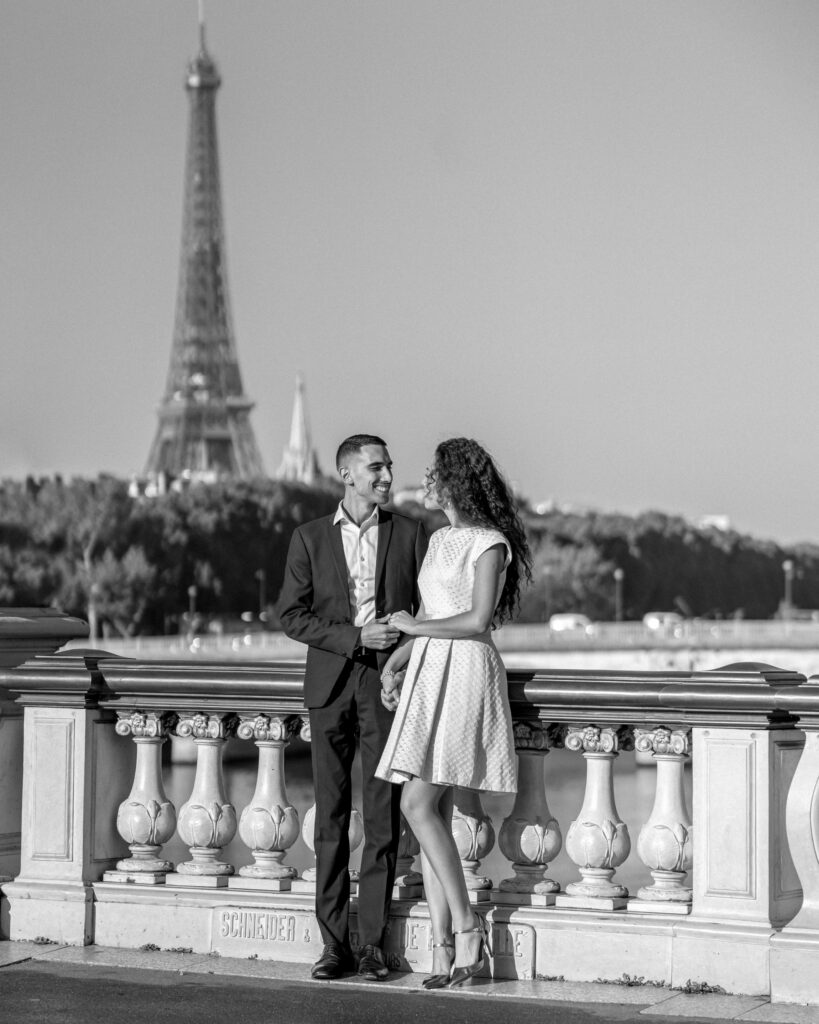 Engagement portrait in front of the Eiffel Tower in Paris.