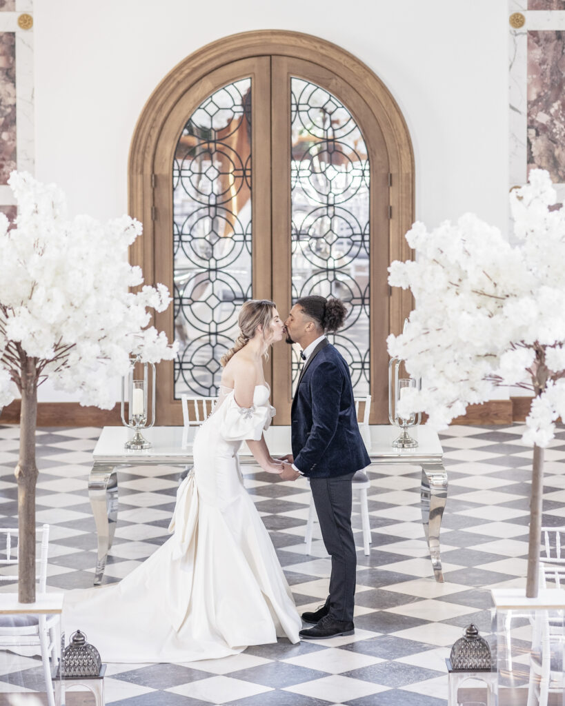 Bride and groom having their first kiss in the Chapel at Hawkstone Hall in Shropshire.