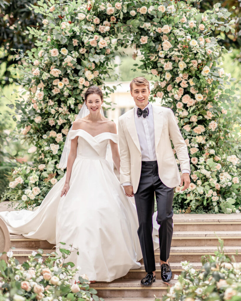 Bride and groom walking back down the aisle after getting married in the gardens of the Ritz, Paris.