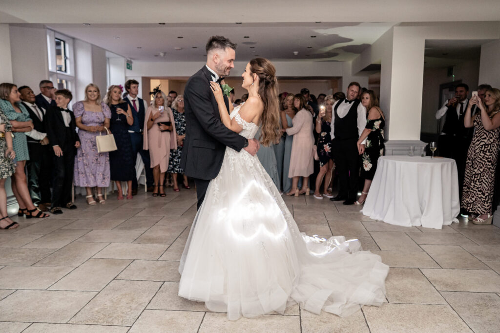 Bride and groom having their first dance in the ballroom at Tyn Dwr Hall.