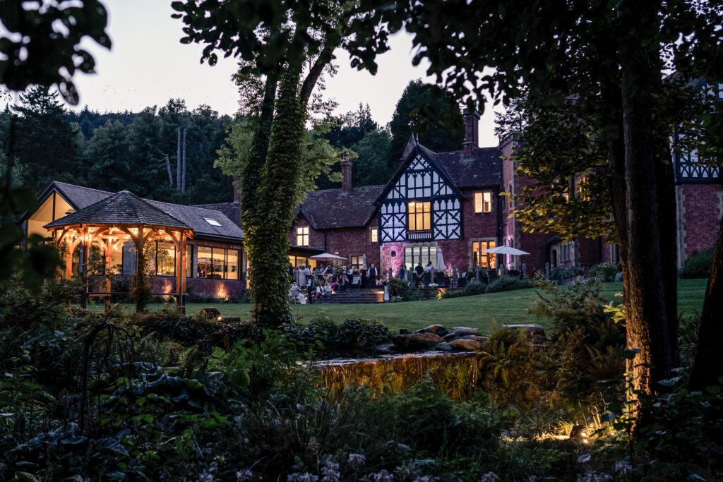 Guest mingling on the outside terrace during the evening reception at Tyn Dwr Hall.