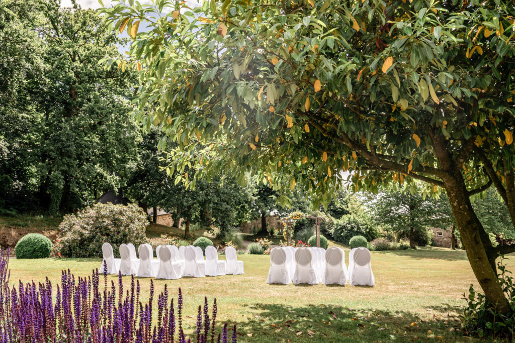 The garden at Chateau du Grand Val  venue in Brittany, France set up for a wedding ceremony outdoors.