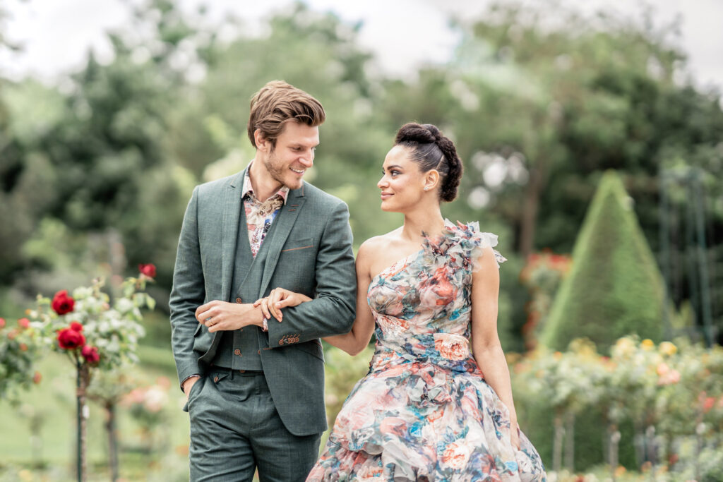 Newlyweds strolling through the park together hand in hand.